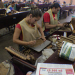This young lady rolls the Flor de las Antillas Toro, the Cigar Of The Year for 2012.