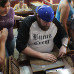 Matt trying his hand at rolling cigars.